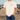 Man wearing an ivory colored t-shirt with the words Fishers of Men from Mark chapter 1 verse 17. Background is a fishing pier.