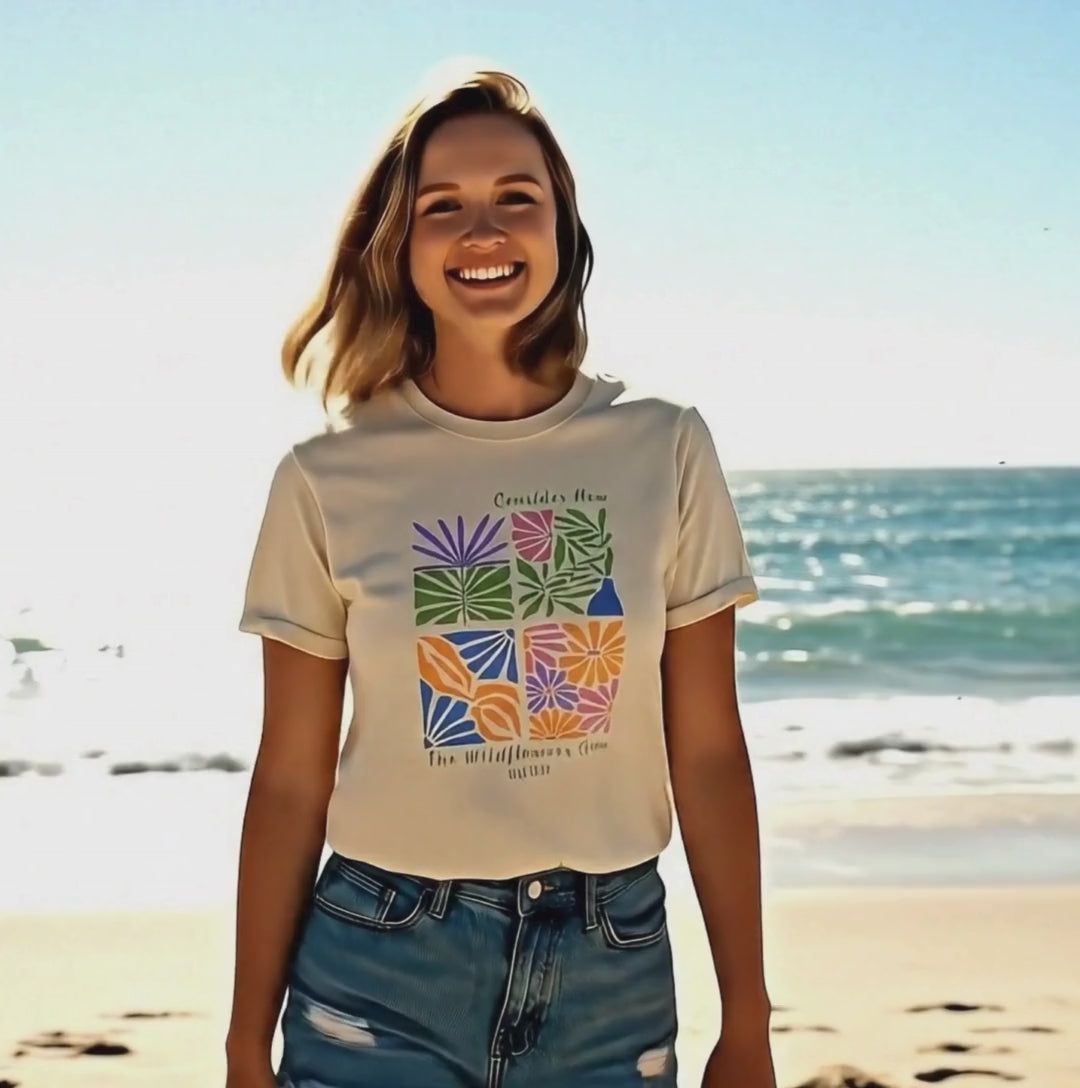 Video of young woman wearing a Consider How the Wildflowers Grow t-shirt from Faith Out Loud.